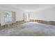 Bright, open living room featuring large windows and some visible framing along the walls at 13982 Whisperwood Dr, Clearwater, FL 33762