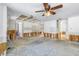 Living room with ceiling fan and views into other rooms at 13982 Whisperwood Dr, Clearwater, FL 33762