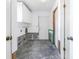 Mud room featuring storage cabinets, door and hookups for a washer and dryer at 13982 Whisperwood Dr, Clearwater, FL 33762