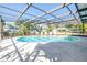 Inviting screened-in pool with a surrounding patio, perfect for outdoor relaxation and entertaining at 13982 Whisperwood Dr, Clearwater, FL 33762