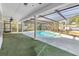 Inviting screened-in pool with a covered patio, perfect for outdoor relaxation and entertaining at 13982 Whisperwood Dr, Clearwater, FL 33762