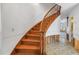 Elegant curved wooden staircase leads to the upper level with views of adjacent rooms at 13982 Whisperwood Dr, Clearwater, FL 33762