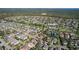 Wide aerial shot of a suburban neighborhood featuring a community pool, walking trails, and a dense tree line at 14123 Barrington Stowers Dr, Lithia, FL 33547