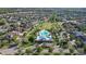 Stunning aerial view of a community pool and clubhouse surrounded by well-maintained lawns and beautiful single-Gathering homes at 14123 Barrington Stowers Dr, Lithia, FL 33547