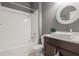Clean bathroom featuring a combined shower and bathtub with white subway tile and modern sink vanity at 14123 Barrington Stowers Dr, Lithia, FL 33547