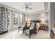 Bright bedroom with large windows, tray ceiling, and stylish decor offers a serene and inviting atmosphere at 14123 Barrington Stowers Dr, Lithia, FL 33547