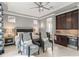 Elegant bedroom with tray ceiling, sitting area, built-in bar, and ensuite bathroom access provides a luxurious retreat at 14123 Barrington Stowers Dr, Lithia, FL 33547