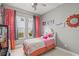 Bright bedroom featuring colorful accents, a cozy bed, and playful decor at 14123 Barrington Stowers Dr, Lithia, FL 33547