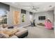 Bonus room with a stationary bike, large screen TV, and comfortable seating area at 14123 Barrington Stowers Dr, Lithia, FL 33547