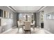 The dining room features tray ceilings, gray walls, neutral drapes and a round wood table at 14123 Barrington Stowers Dr, Lithia, FL 33547