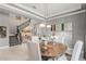 View of the dining room with art, gray walls and a staircase leading to the second floor at 14123 Barrington Stowers Dr, Lithia, FL 33547