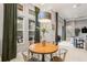A dining area with green drapes, decorative center piece, and view of the outdoor area through large windows at 14123 Barrington Stowers Dr, Lithia, FL 33547