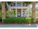 Inviting front exterior with palm trees, a porch with columns, and a manicured garden at 14123 Barrington Stowers Dr, Lithia, FL 33547