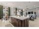 Spacious kitchen island with dark wood cabinets, white countertop, and pendant lighting at 14123 Barrington Stowers Dr, Lithia, FL 33547