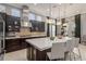 Bright kitchen with stainless steel appliances, a large island and dark wood cabinets at 14123 Barrington Stowers Dr, Lithia, FL 33547