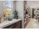 Kitchen view with white countertops, stainless steel appliances and natural light from the garden window at 14123 Barrington Stowers Dr, Lithia, FL 33547