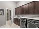 Laundry room featuring modern washer and dryer, ample counter space and nice cabinets at 14123 Barrington Stowers Dr, Lithia, FL 33547