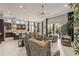 Spacious open-concept living space with kitchen, dining area, and comfortable seating with access to the patio at 14123 Barrington Stowers Dr, Lithia, FL 33547