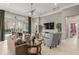 Bright living room with comfortable seating, neutral tones, large windows, and access to the outdoor patio at 14123 Barrington Stowers Dr, Lithia, FL 33547