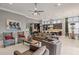 Open-concept living room featuring a kitchen, dining area, and comfortable seating, perfect for entertaining guests at 14123 Barrington Stowers Dr, Lithia, FL 33547
