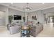 Relaxing living room with a large tv, comfortable seating, and stylish decor with view into another room at 14123 Barrington Stowers Dr, Lithia, FL 33547