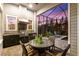 Screened-in patio with an outdoor kitchen, dining set, and serene twilight views of the pool at 14123 Barrington Stowers Dr, Lithia, FL 33547