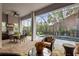 Inviting screened patio with an outdoor kitchen, dining area, and a view of the relaxing pool at 14123 Barrington Stowers Dr, Lithia, FL 33547