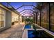 Beautifully designed screened pool area with brick pavers, tranquil water, a spa, and comfortable outdoor seating at 14123 Barrington Stowers Dr, Lithia, FL 33547