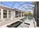 Screened pool and spa with patio area, perfect for outdoor gatherings and relaxation by the refreshing water at 14123 Barrington Stowers Dr, Lithia, FL 33547