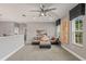 A cozy sitting area with a comfortable sofa, large windows, and ample natural light at 14123 Barrington Stowers Dr, Lithia, FL 33547