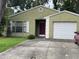 Charming one-story home with an attached garage and a well-manicured front yard at 1706 E Fern St, Tampa, FL 33610