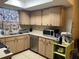 Functional kitchen with wooden cabinets, modern appliances, and a sink at 1706 E Fern St, Tampa, FL 33610