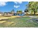 Expansive backyard with lush green grass, a trampoline, and a shed under a blue sky at 2035 Ronald Cir, Seffner, FL 33584