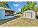 Backyard view featuring a fenced in porch, storage shed and trampoline at 2035 Ronald Cir, Seffner, FL 33584