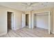 Clean bedroom features a ceiling fan, a window for natural light, and open closet at 2035 Ronald Cir, Seffner, FL 33584