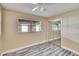 Bedroom with wood-look flooring, closet, ceiling fan, and a neutral color palette at 2035 Ronald Cir, Seffner, FL 33584