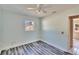 Bedroom with wood-look flooring, ceiling fan, and a neutral color palette at 2035 Ronald Cir, Seffner, FL 33584