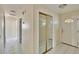 Neutral hallway with tile flooring, closet with mirrored doors, and a white front door at 2035 Ronald Cir, Seffner, FL 33584
