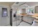 Efficient kitchen layout with stainless steel appliances and window views at 2035 Ronald Cir, Seffner, FL 33584