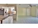 Open floor plan connecting the living room, dining area, and kitchen with tile flooring at 2035 Ronald Cir, Seffner, FL 33584