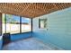 Enclosed porch featuring textured lattice ceiling and a view to the fenced backyard at 2035 Ronald Cir, Seffner, FL 33584