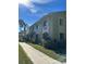 A charming multi-Gathering home with well-maintained landscaping and palm trees on a sunny day at 20861 Haulover Cv # 5, Lutz, FL 33558