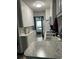 Modern kitchen featuring white cabinets, marble countertops, and stainless steel appliances at 20861 Haulover Cv # 5, Lutz, FL 33558