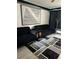 Modern living room featuring sleek black sofas, geometric art, and stylish decor at 20861 Haulover Cv # 5, Lutz, FL 33558