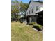 Backyard view of the property with a lush green lawn and mature trees adding shade at 2440 Enterprise Rd # 2, Clearwater, FL 33763