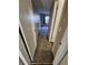 Carpeted hallway with neutral walls leading to a bedroom with a window at 2440 Enterprise Rd # 2, Clearwater, FL 33763