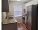 A functional kitchen featuring stainless steel appliances, granite countertops, and wood-look flooring at 2440 Enterprise Rd # 2, Clearwater, FL 33763