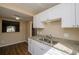 Bright kitchen with granite countertops and white cabinets at 2440 Enterprise Rd # 2, Clearwater, FL 33763