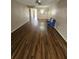 Bright living room with modern ceiling fan and a smooth transition to laminate flooring at 2440 Enterprise Rd # 2, Clearwater, FL 33763