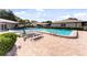 Community pool with lounge chairs and a brick surround, ideal for relaxation and recreation at 2440 Enterprise Rd # 2, Clearwater, FL 33763